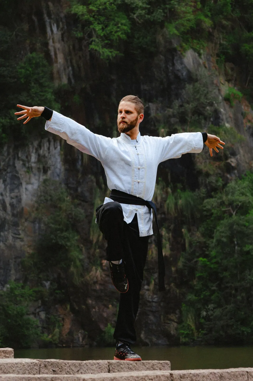 Tai chi practiced slowly in a park at first light